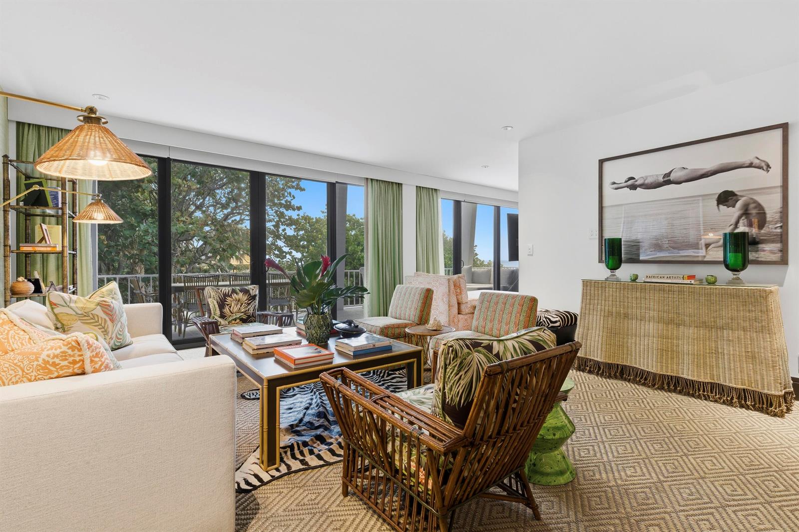 A living room features a rattan chair, a zebra-print rug, and a large framed photograph — 2275 S Ocean Boulevard # 207n, Palm Beach FL 33480, PALM BEACH, FL