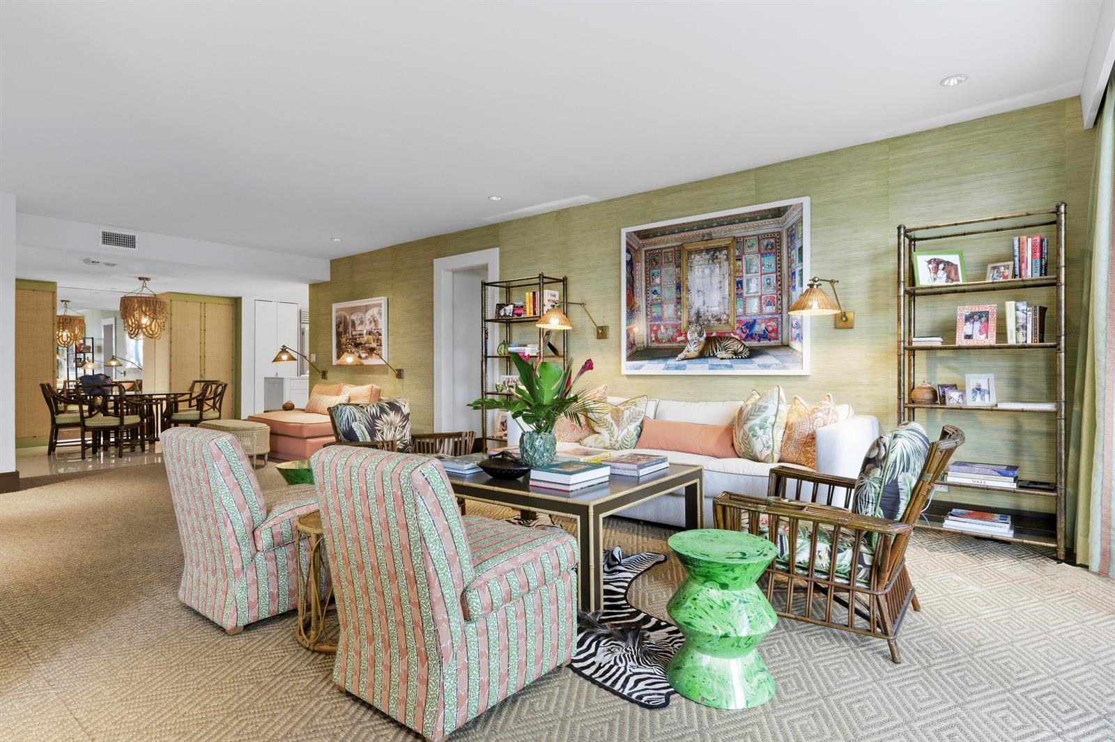 A living room features patterned armchairs, a white sofa, bamboo shelving, and green textured wallpaper — 2275 S Ocean Boulevard # 207n, Palm Beach FL 33480, PALM BEACH, FL