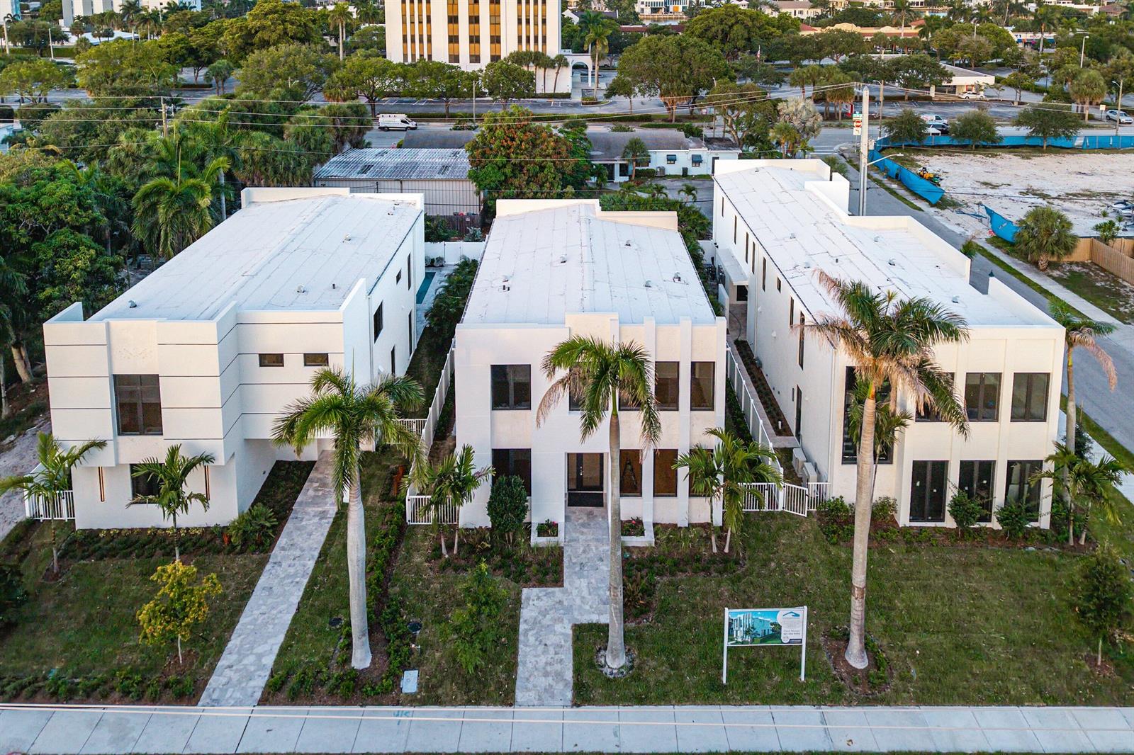 An aerial view shows three modern white two-story townhouses with flat roofs and palm trees — 731 SE 4th Avenue, Delray Beach FL 33483, DELRAY BEACH, FL