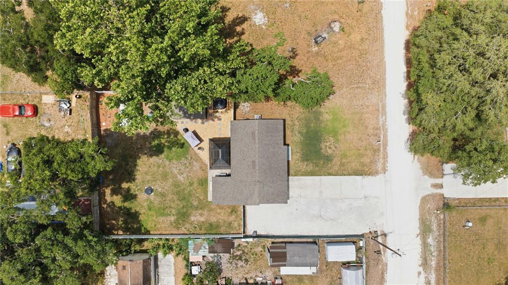 An aerial view shows a house with a screened patio surrounded by trees and grass — 1512 NE 37TH STREET, OCALA, FL