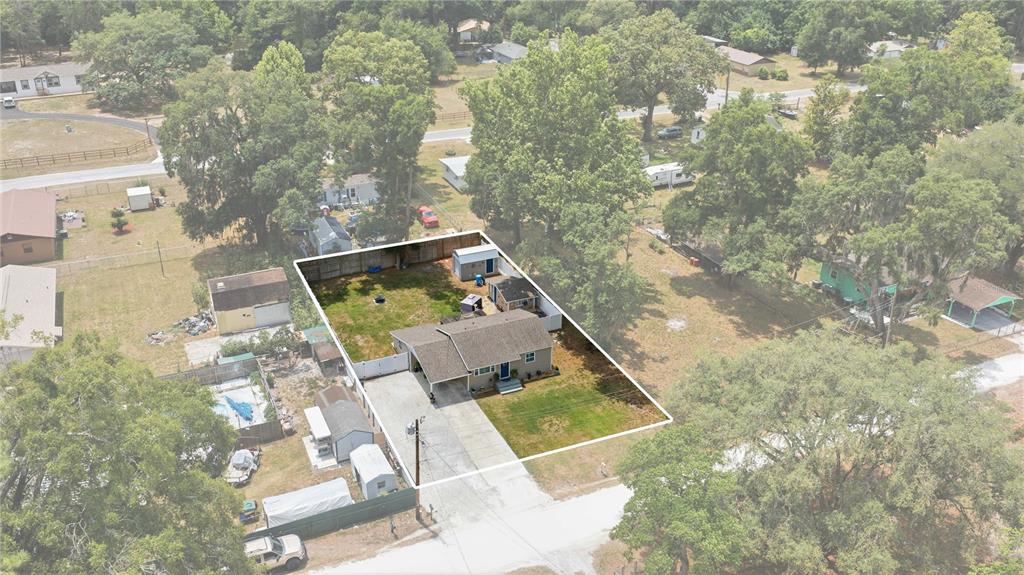 An aerial view shows a single-story house with a carport and fenced backyard — 1512 NE 37TH STREET, OCALA, FL