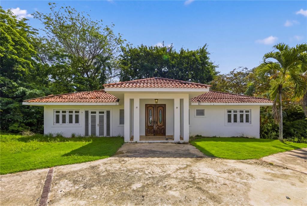 A single-story white house with a red tile roof and a central covered entryway — 7 VANDA, GUAYNABO, PR