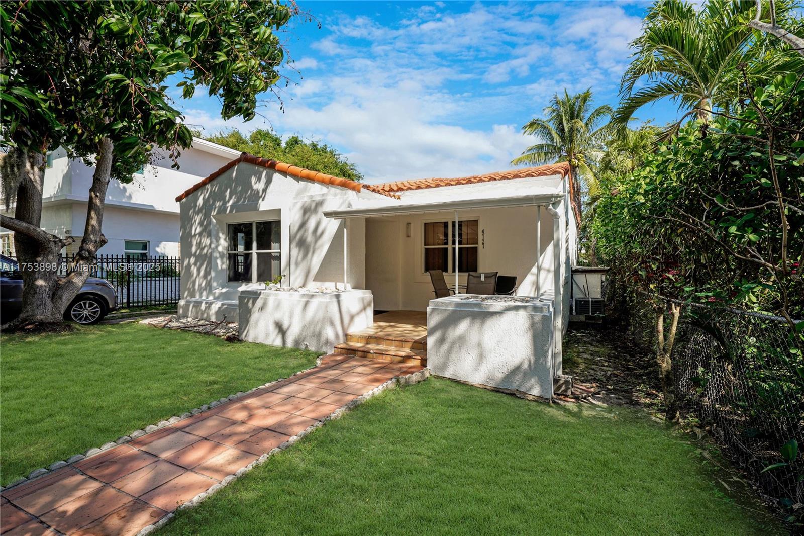 A single-story white stucco house with a tiled roof and a front porch — 4727 NE 1st Ct, Miami FL 33137, MIAMI, FL