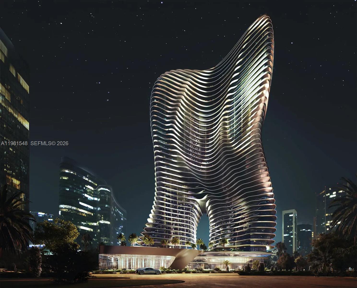 This is a rendering of a modern, curved skyscraper with a distinctive cutout base at night — 284032 Marasi Drive # 0, Dubai, FL
