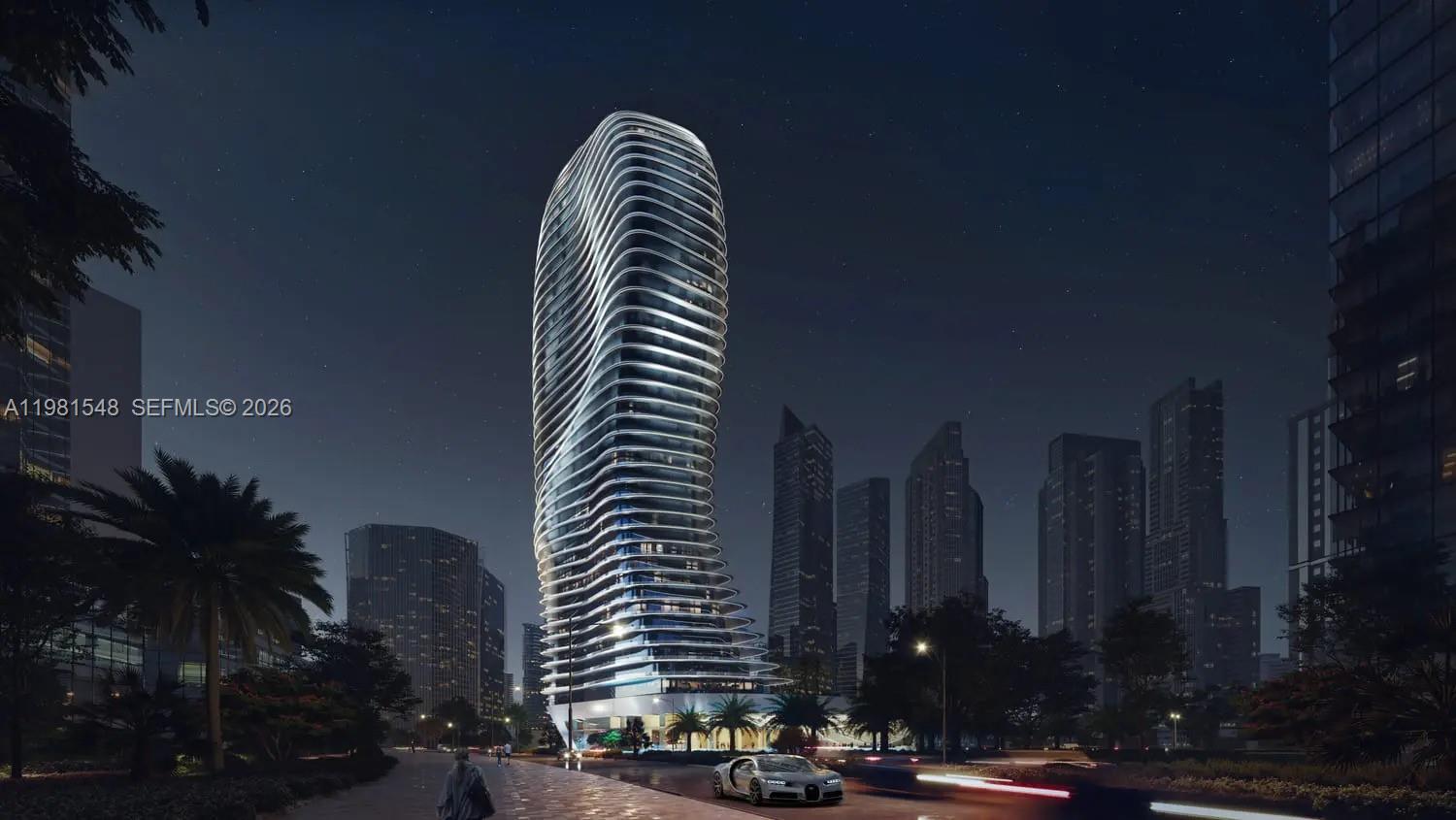This is a rendering of a modern, curved skyscraper at night with a car parked nearby — 284032 Marasi Drive # 0, Dubai, FL