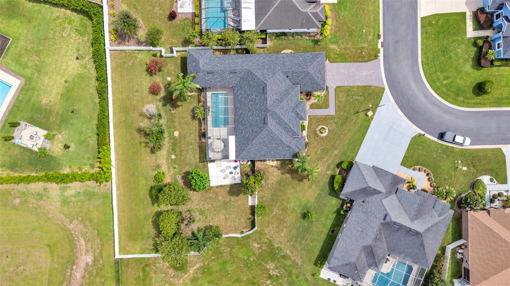 An aerial view shows a residential house with a pool, patio, and fenced backyard — 6726 HARTSWORTH DRIVE, LAKELAND, FL