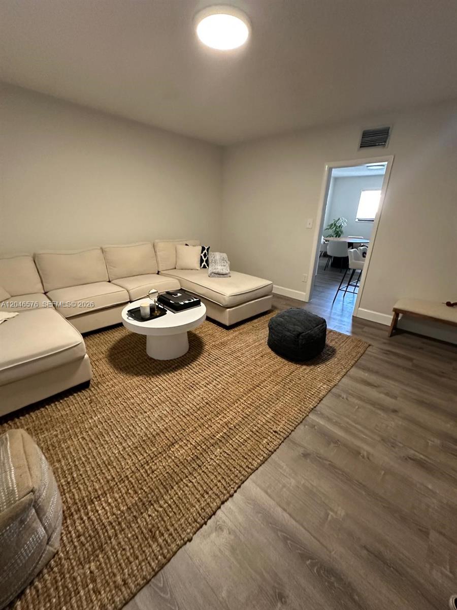 A living room features a large beige sectional sofa, a round coffee table, and a rug — 6805 SW 88th St # 8, Pinecrest FL 33156, PINECREST, FL