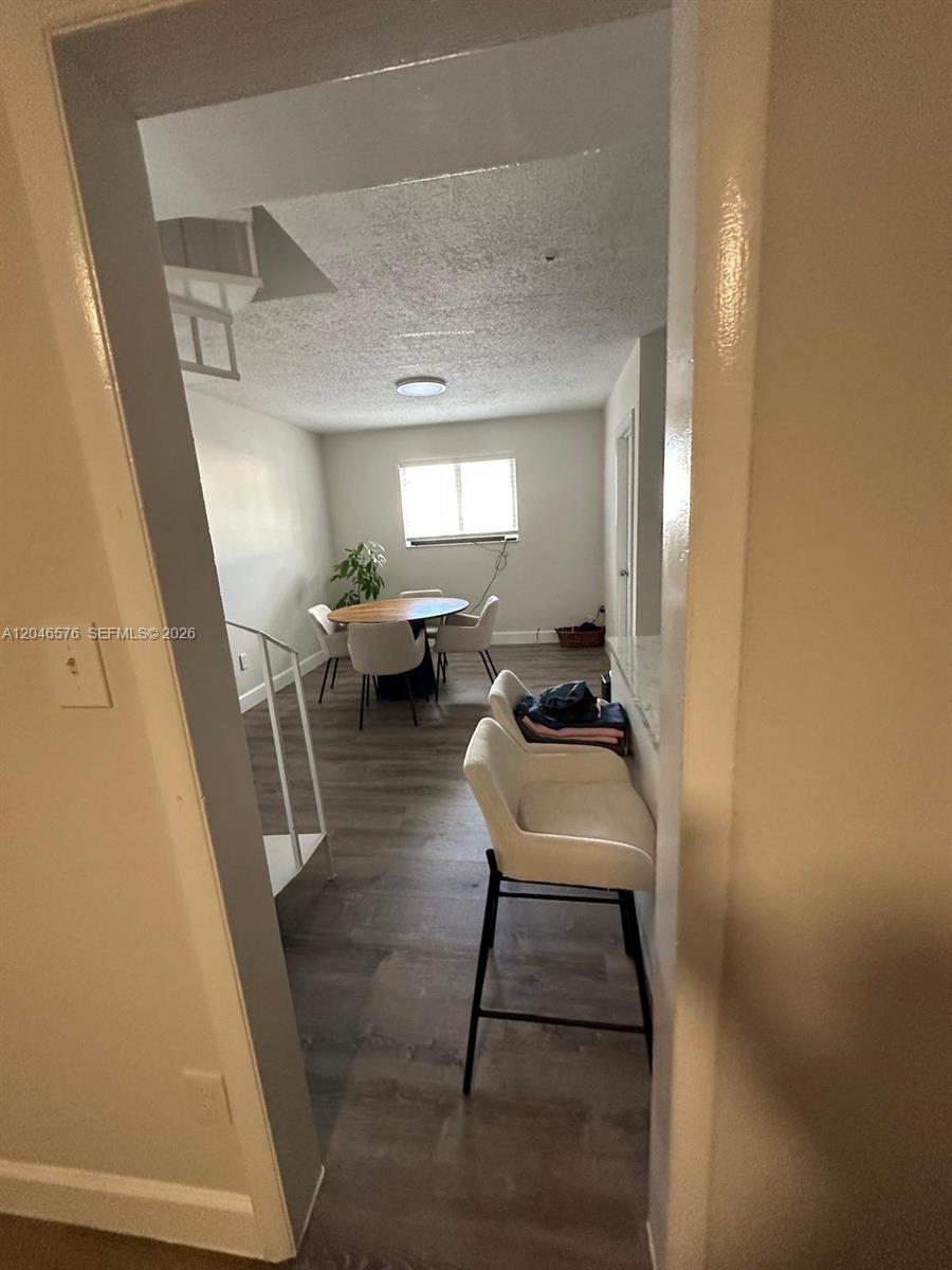 A dining area with a round table and chairs sits adjacent to a kitchen counter — 6805 SW 88th St # 8, Pinecrest FL 33156, PINECREST, FL