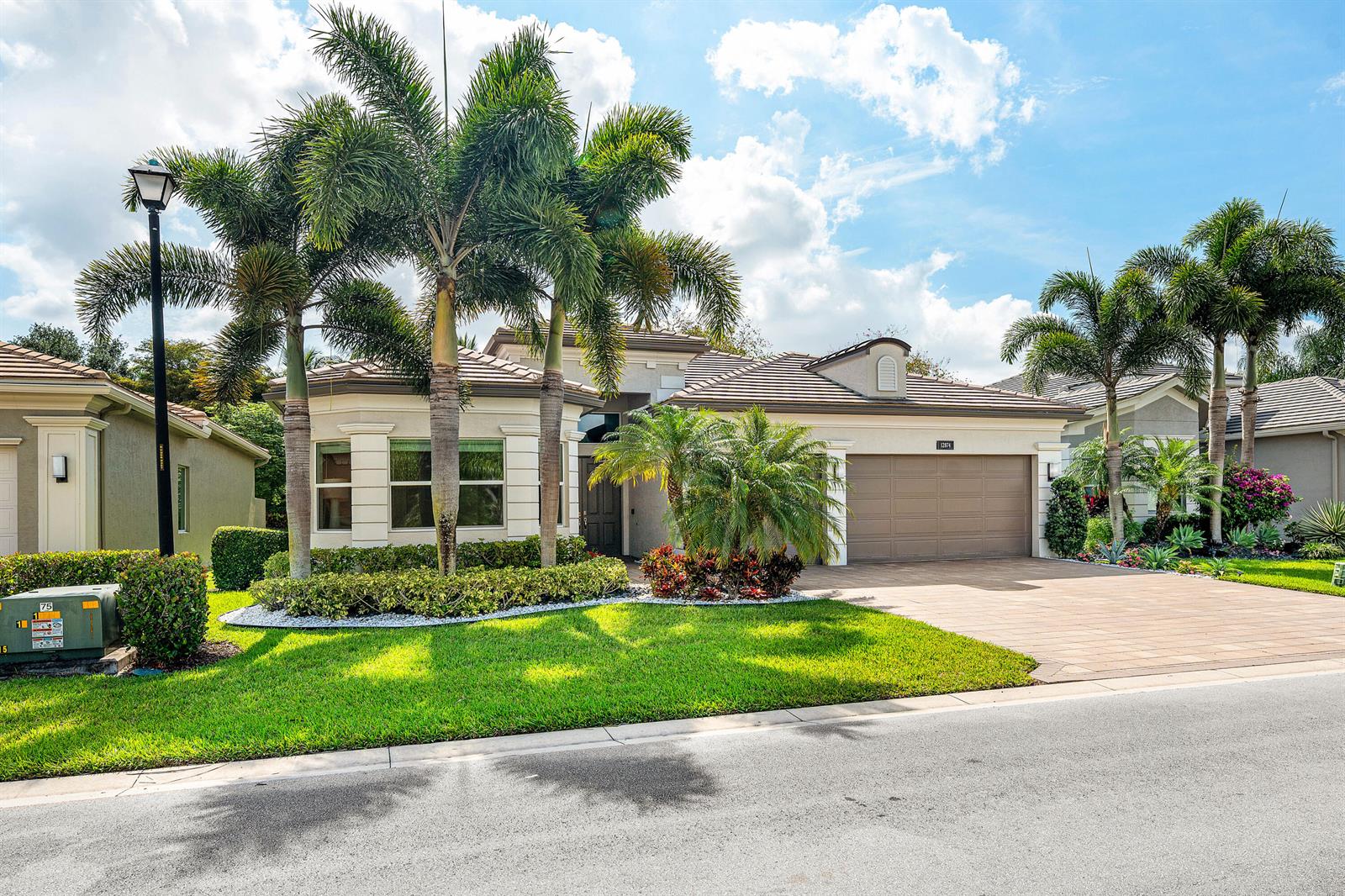 A single-story house with a paved driveway, palm trees, and a two-car garage — 12874 Granite Mountain Pass, Boynton Beach FL 33473, BOYNTON BEACH, FL