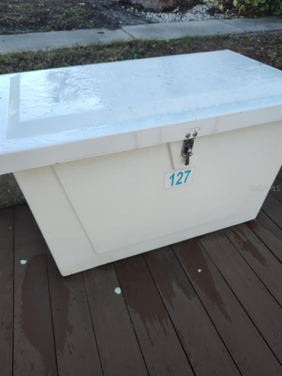 A white storage chest with the number 127 sits on a wooden deck — 127ss COQUINA KEY DR SE DRIVE, ST PETERSBURG, FL