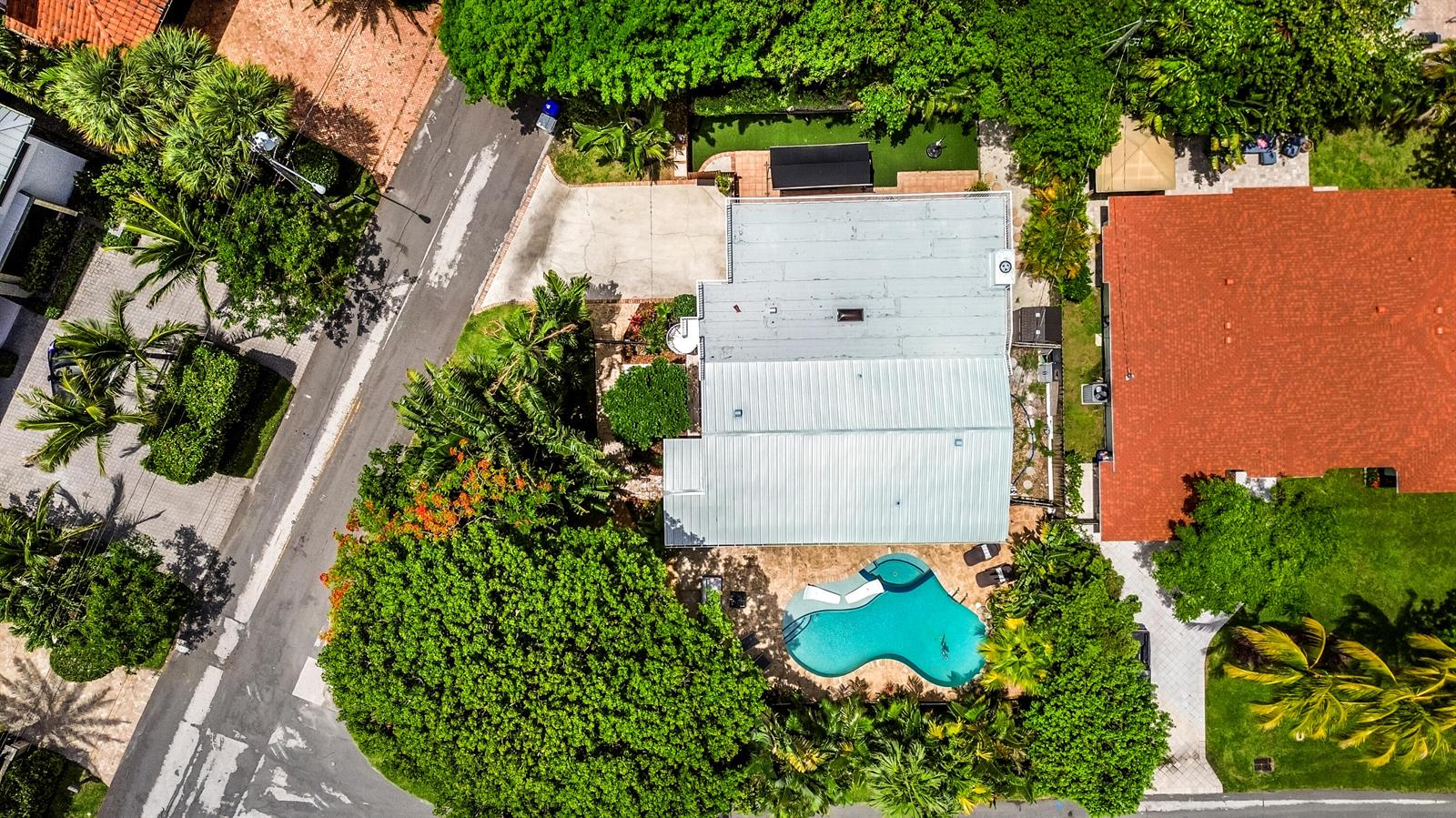 An aerial view shows a house with a metal roof, a pool, and surrounding trees — 2400 N Riverside Drive, Pompano Beach FL 33062, POMPANO BEACH, FL