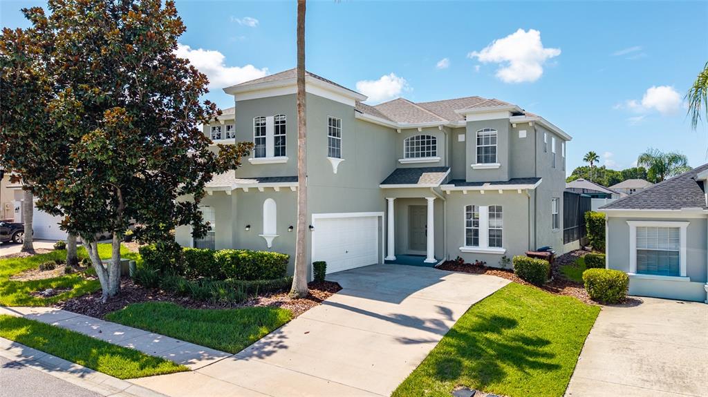 A two-story, light green suburban house with a white garage and a concrete driveway — 526 PINELOCH DRIVE, HAINES CITY, FL