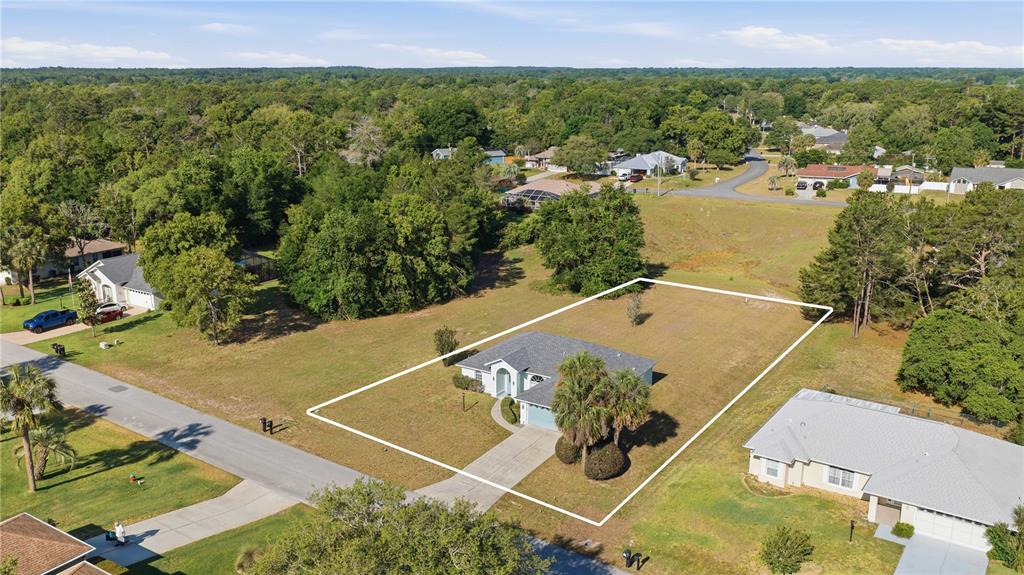 An aerial view shows a single-story house with a large yard outlined in white — 10772 SW 53RD CIRCLE, OCALA, FL