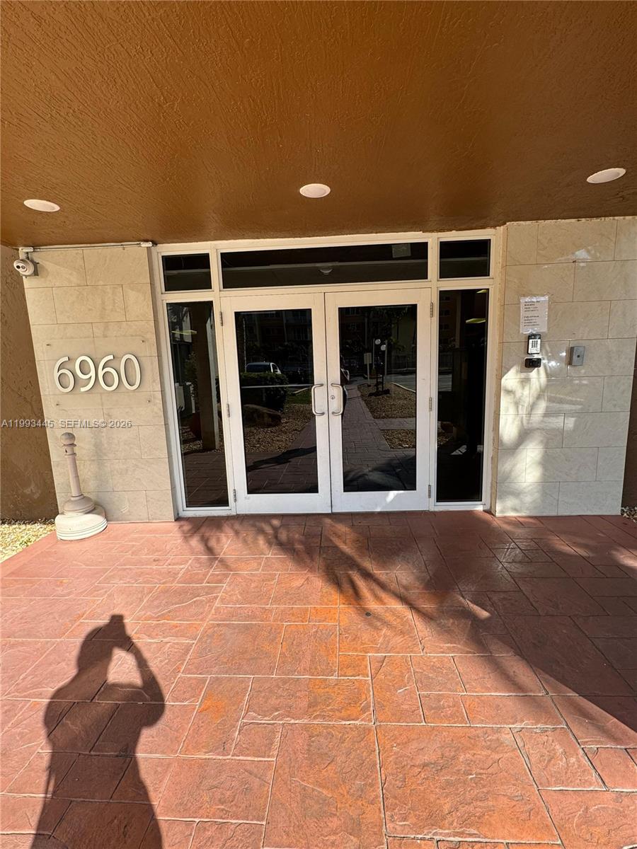 The exterior entrance features double glass doors, a tiled patio, and the number 6960 — 6960 Miami Gardens Dr # 516, Hialeah FL 33015, HIALEAH, FL
