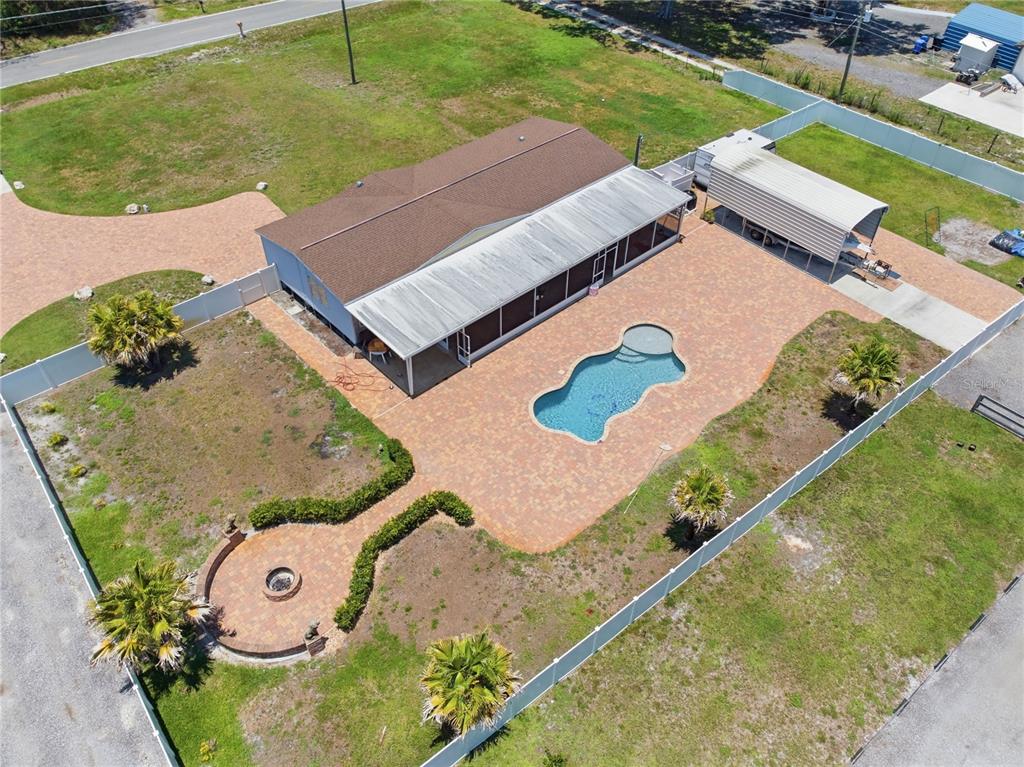 An aerial view shows a house with a pool, patio, and detached carport within a fence — 6502 FIVE ACRE ROAD, PLANT CITY, FL