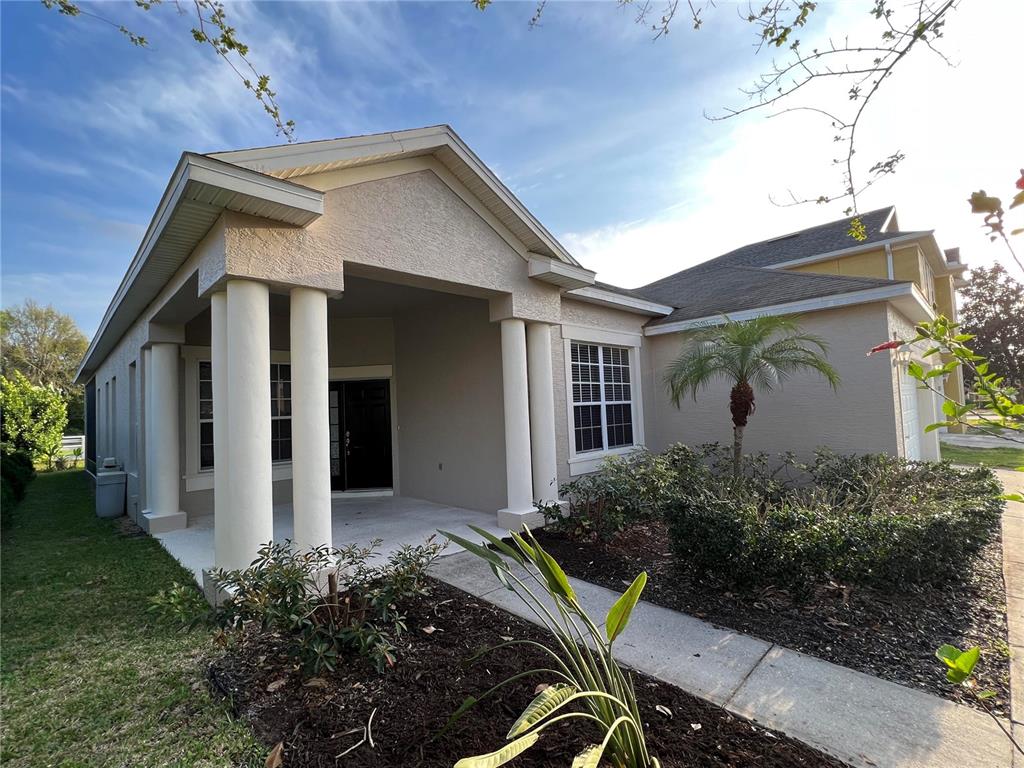 A single-story house with a covered front porch, white columns, and a landscaped front yard — 365 JAMES CIRCLE, LAKE ALFRED, FL
