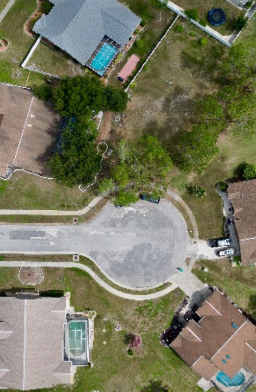 An aerial view shows a cul-de-sac surrounded by residential homes with pools and yards — 5142 LA PLATA DRIVE, NEW PORT RICHEY, FL