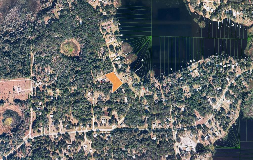 An aerial view shows a highlighted orange property lot situated near a lake and trees — 161 LITTLE ORANGE LAKE DRIVE, HAWTHORNE, FL