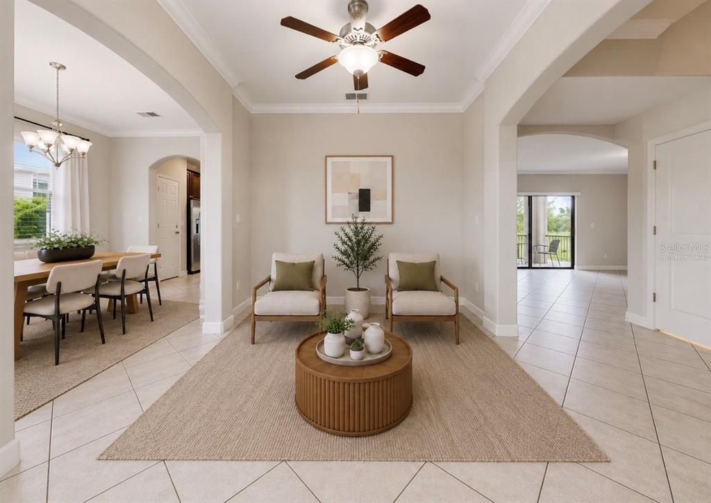 A living area with two chairs and a coffee table sits between a dining room — 9924 SMARTY JONES DRIVE, RUSKIN, FL