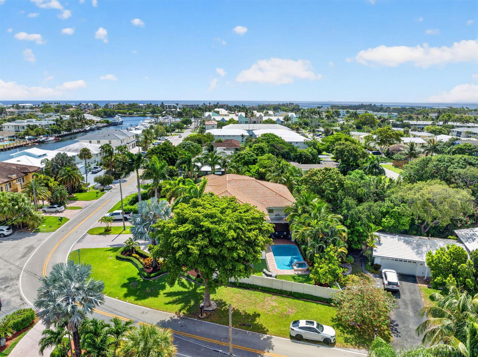 An aerial view shows a house with a pool, surrounded by trees and a road — 2844 NE 26th Avenue, Lighthouse Point FL 33064, LIGHTHOUSE POINT, FL