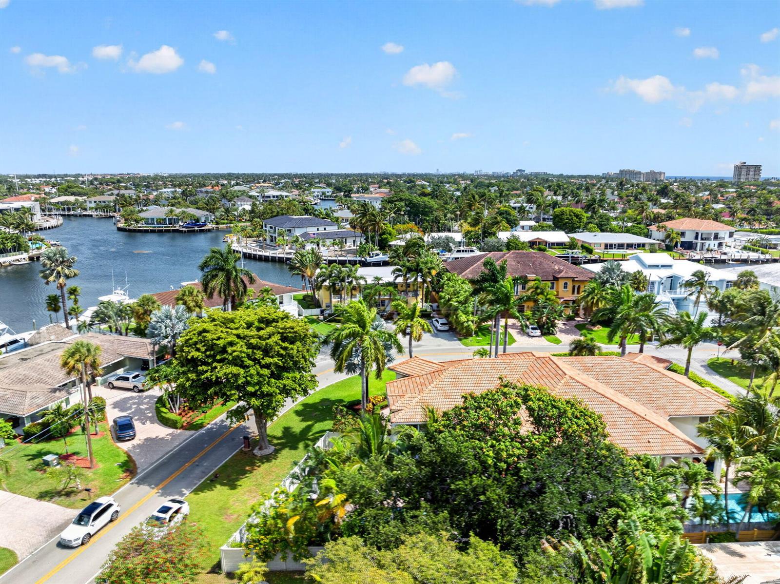 An aerial view shows a residential neighborhood with houses, palm trees, and a winding canal — 2844 NE 26th Avenue, Lighthouse Point FL 33064, LIGHTHOUSE POINT, FL