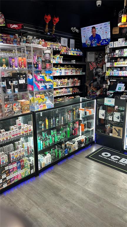 A retail store interior features glass display cases filled with various tobacco and vaping products — 0000 WEST LINEBAUGH AVENUE, TAMPA, FL