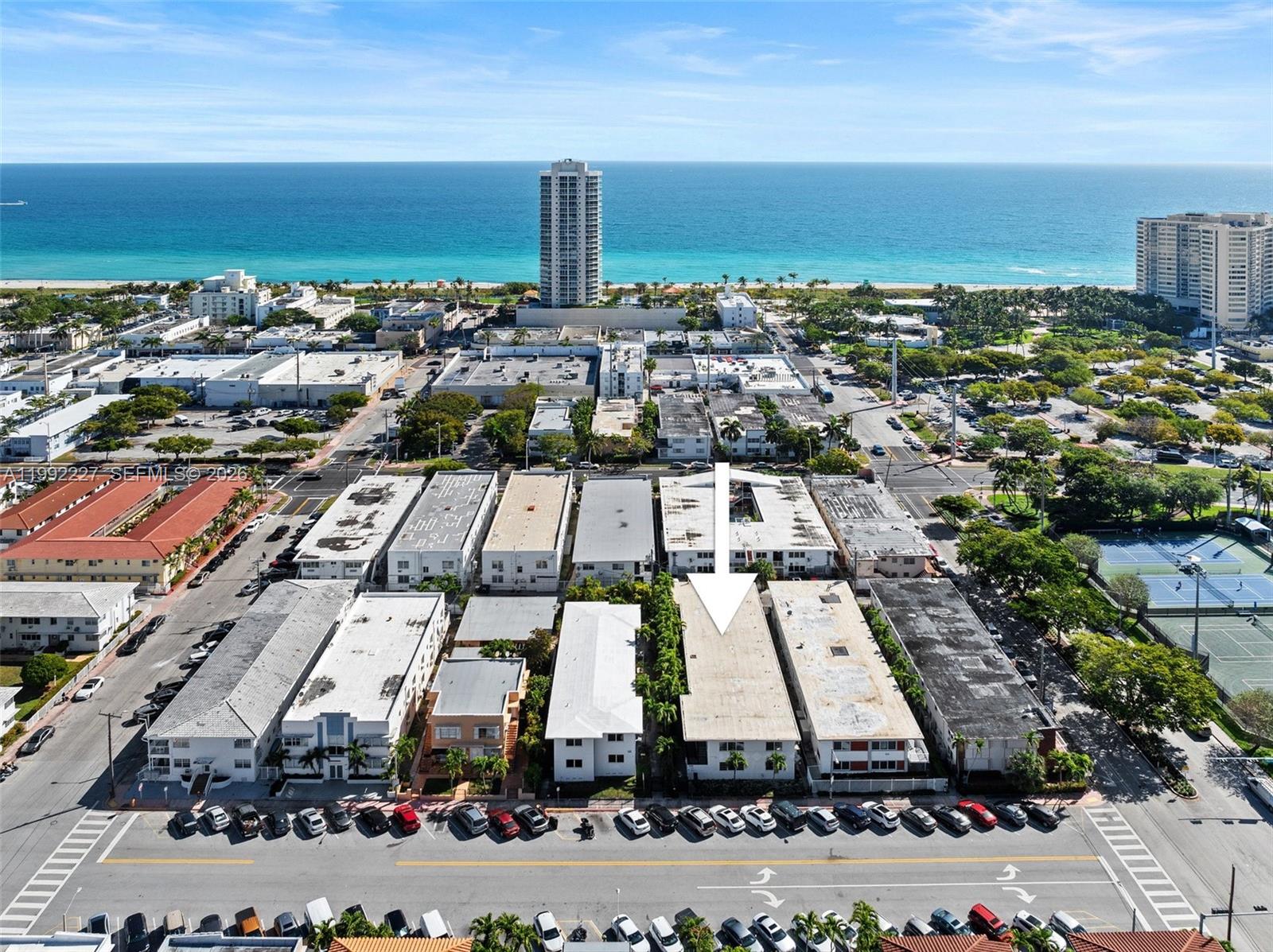 An aerial view shows a multi-story apartment building with a white arrow pointing to its roof — 7315 Byron Ave # 10, Miami Beach FL 33141, MIAMI BEACH, FL
