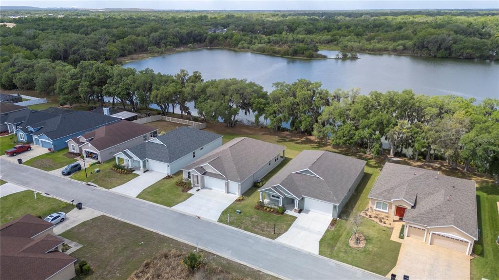 A single-story house with a light green exterior, a two-car garage, and a covered porch — 4537 FAIRWAY OAKS DRIVE, MULBERRY, FL