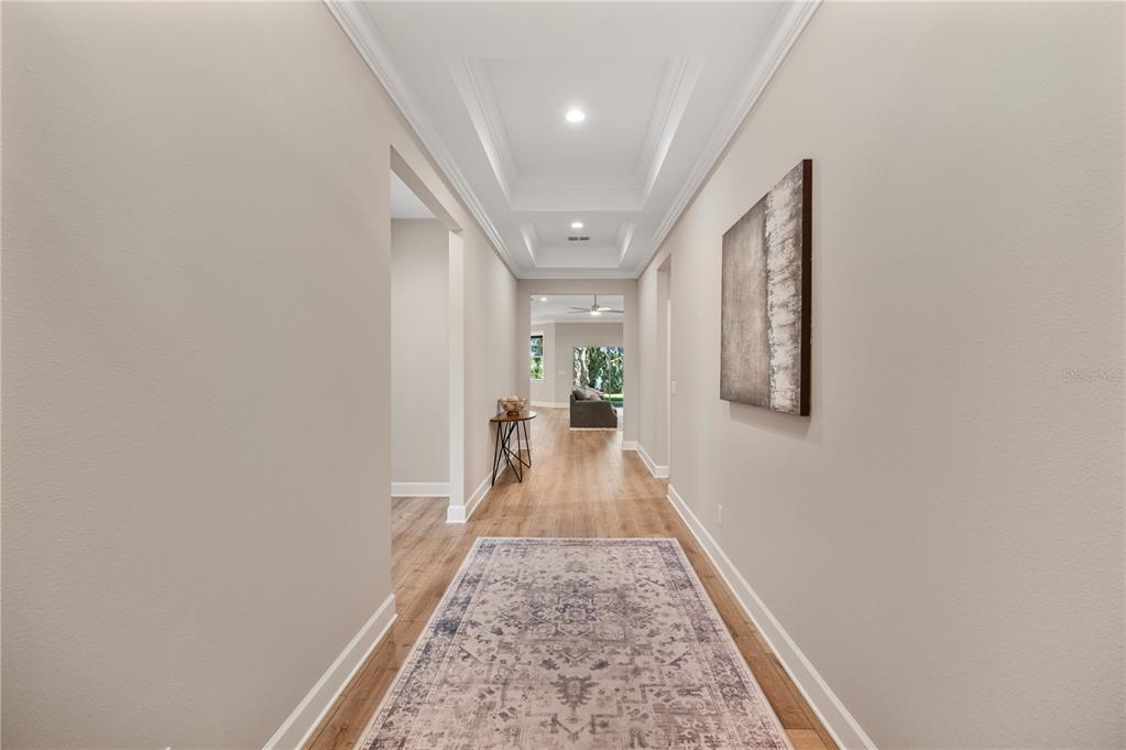 A covered front porch features a concrete floor, stone-based columns, and a large window — 4537 FAIRWAY OAKS DRIVE, MULBERRY, FL