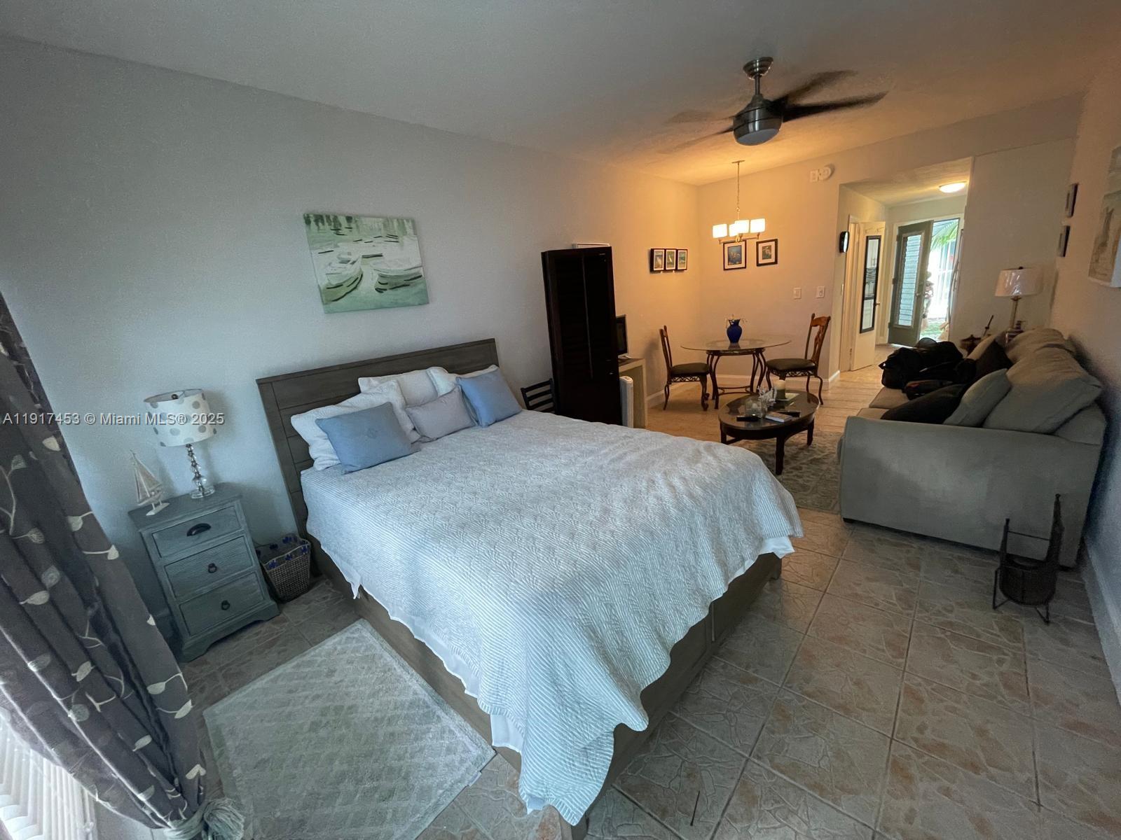 This studio apartment features a bed, dining area, and living space with tile flooring — 6490 Collins Ave # 5, Miami Beach FL 33141, MIAMI BEACH, FL