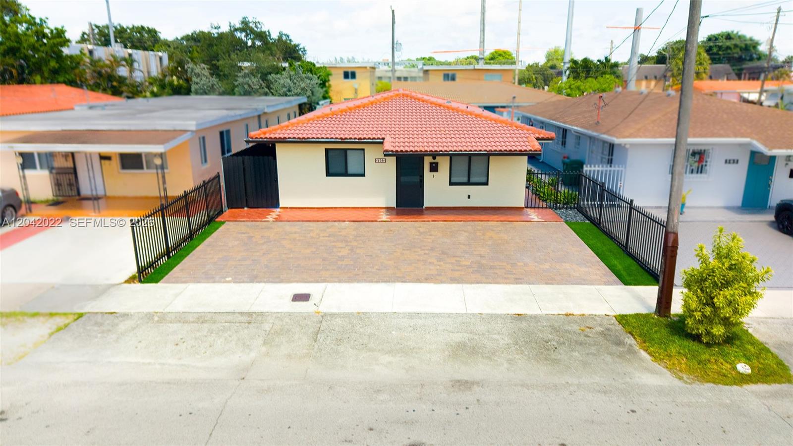 An exterior view of a single-story house with a red tile roof and paved driveway — 509 NW 57th Ct, Miami FL 33126, MIAMI, FL