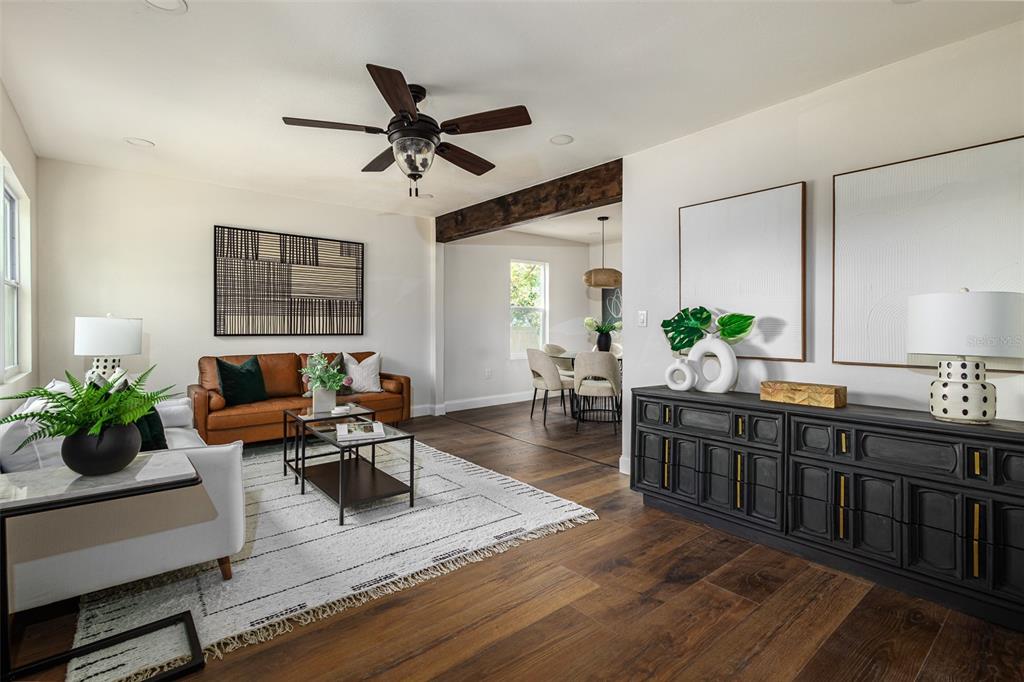 A living room with a leather sofa, dark wood floors, and a black sideboard — 1008 E NORFOLK STREET, TAMPA, FL