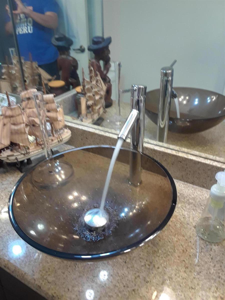 A modern glass vessel sink with a chrome faucet sits on a granite countertop — 54 Matador Lane, Davie FL 33324, DAVIE, FL