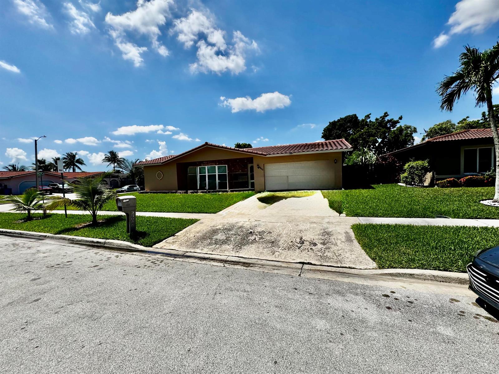 A single-story house with a tiled roof, a two-car garage, and a concrete driveway — 6600 NW 23rd Street, Margate FL 33063, MARGATE, FL