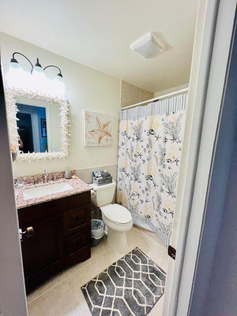 A bathroom features a vanity with a granite countertop, a toilet, and a coastal-themed shower curtain — 1540 Lantana Lane, FL 33043, FL