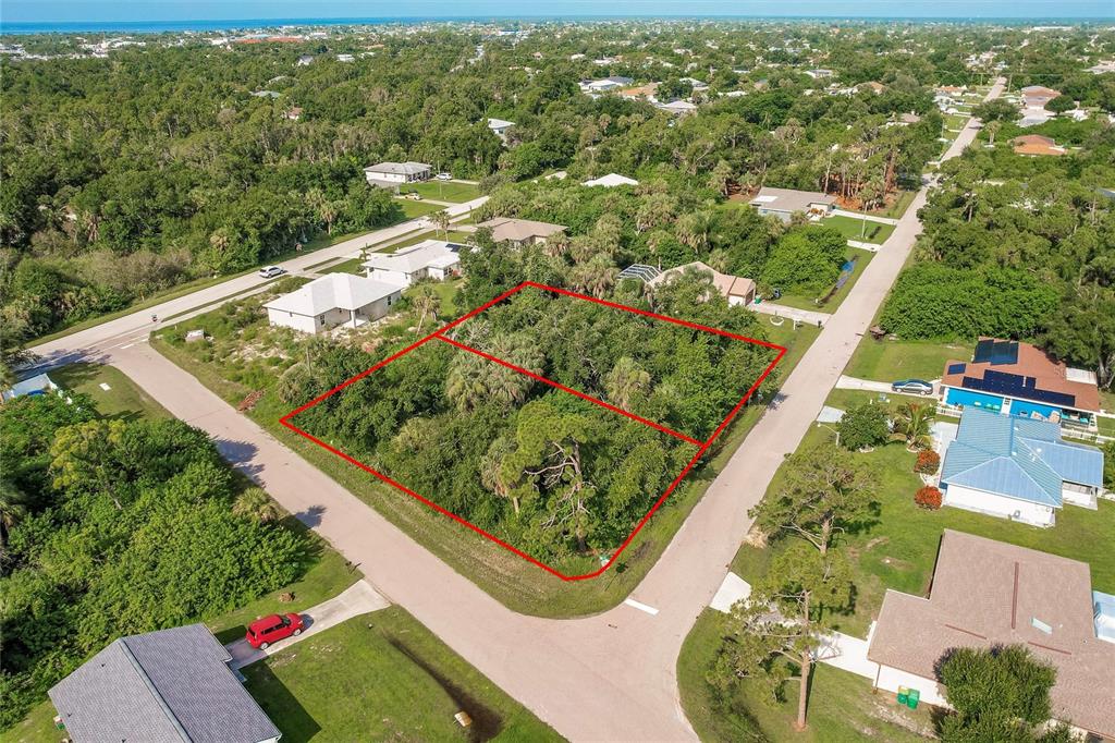 An aerial view of two adjacent, undeveloped, wooded residential lots outlined in red — 23193 RYE AVENUE, PUNTA GORDA, FL