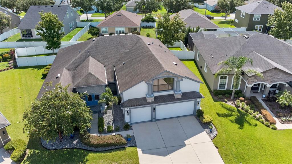 An aerial view shows a suburban house with a multi-car garage and a large lawn — 2823 COLEWOOD LANE, DOVER, FL