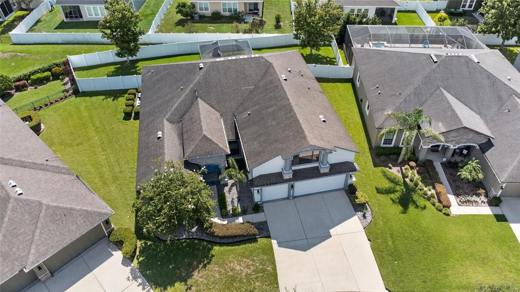 An aerial view shows a suburban house with a dark roof and a concrete driveway — 2823 COLEWOOD LANE, DOVER, FL