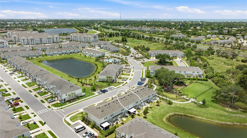An aerial view shows a multi-unit residential building with a circled roof section — 15067 GINETTI STREET, NOKOMIS, FL