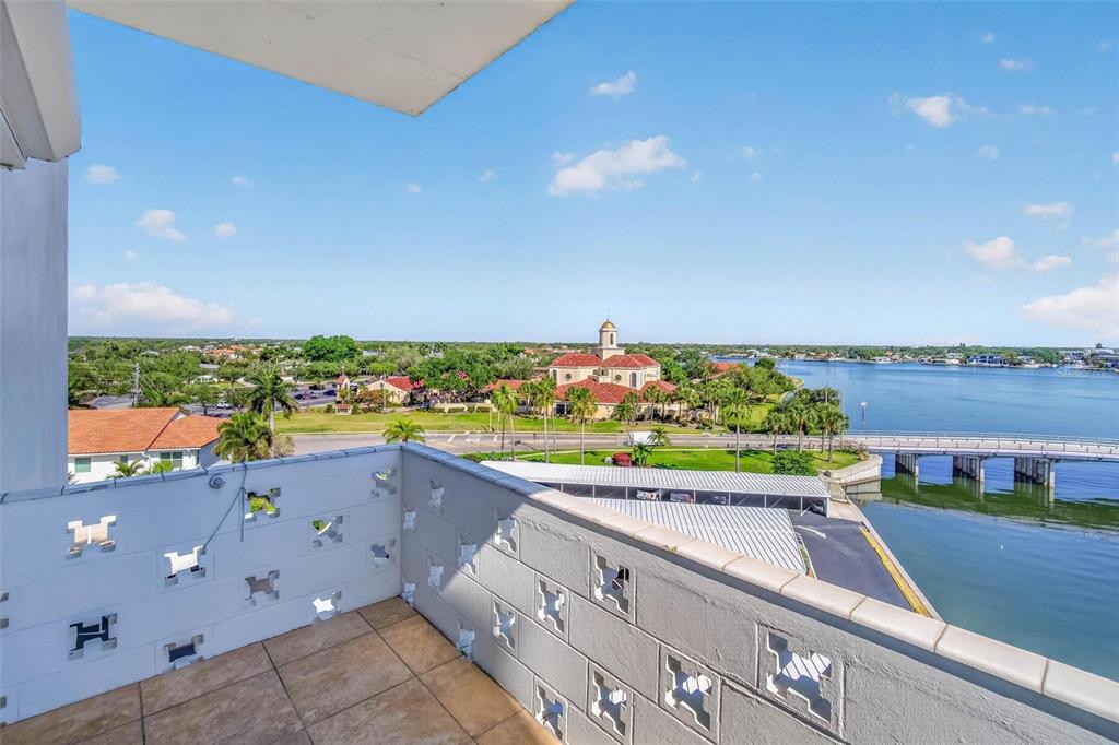 A balcony with decorative concrete block walls overlooks a body of water and a bridge — 1365 SNELL ISLE BOULEVARD NE UNIT 6A, ST PETERSBURG, FL