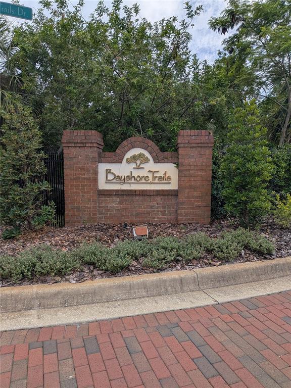 A brick monument sign for Bayshore Trails stands behind a landscaped bed and brick walkway — 2889 BAYSHORE TRAILS DRIVE, TAMPA, FL