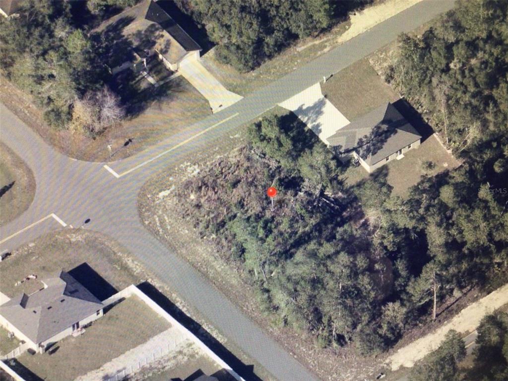 This aerial view shows a vacant, wooded residential lot marked by a red pin — 0 SW 165 STREET ROAD, OCALA, FL