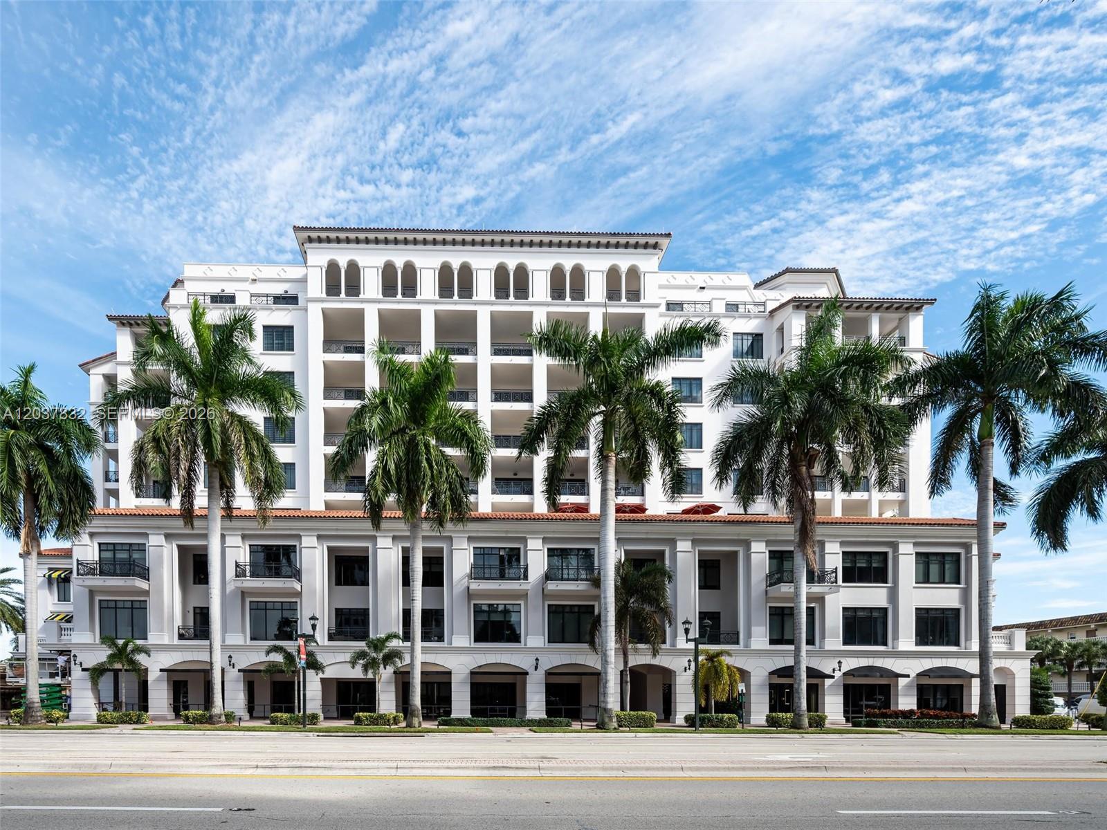 A multi-story white building with arched windows and palm trees stands along a street — 200 E Palmetto Park Rd # 700, Boca Raton FL 33432, BOCA RATON, FL