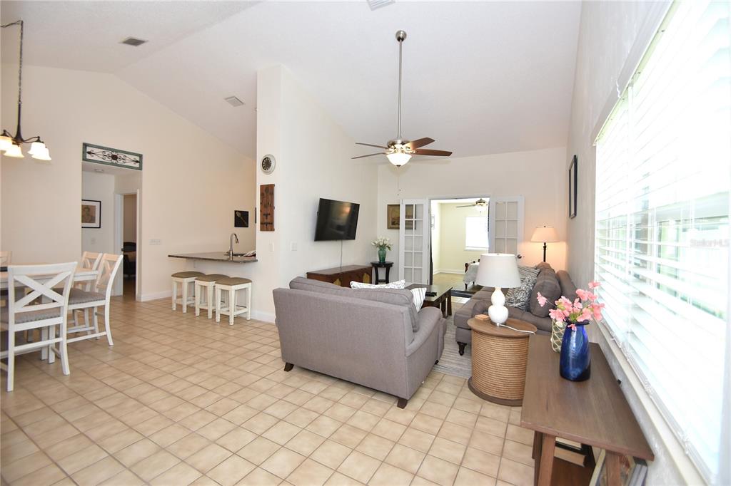 A living room with tile floors, a kitchen bar, and a ceiling fan — 34 ANDOVER DRIVE, PALM COAST, FL