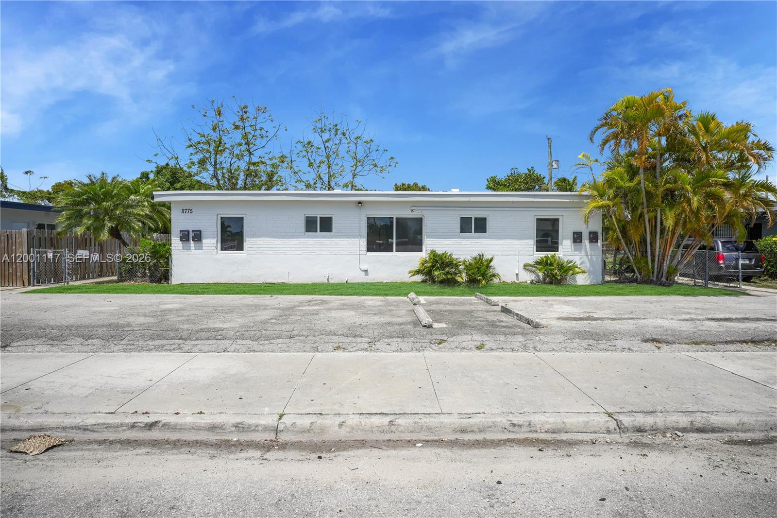 A single-story white brick building with a flat roof sits behind a paved parking area — 11775 SW 223rd St, Miami FL 33170, MIAMI, FL