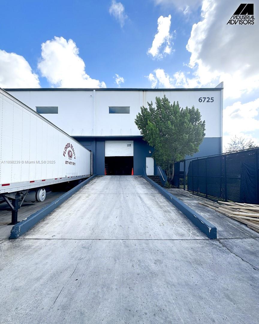 A concrete loading ramp leads to a warehouse bay door at a commercial building — 6725 NW 36th St, Miami FL 33166, MIAMI, FL