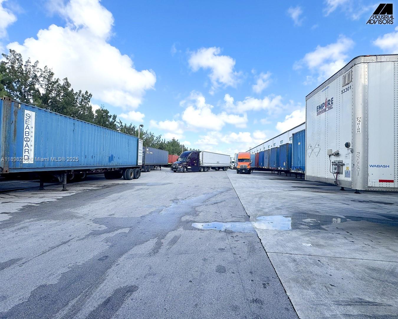 A paved industrial shipping yard with multiple semi-trucks and cargo trailers parked in rows — 6725 NW 36th St, Miami FL 33166, MIAMI, FL