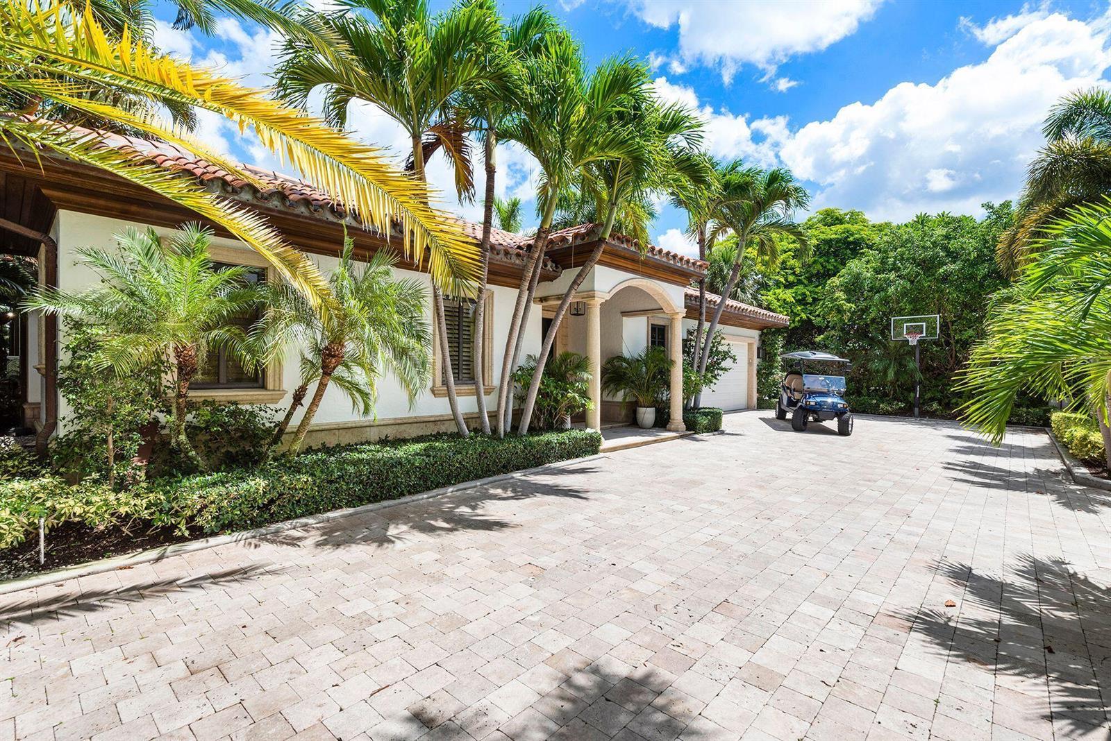 A paved driveway leads to a single-story house with palm trees and a golf cart — 14 Harbor Drive, FL 33460, FL