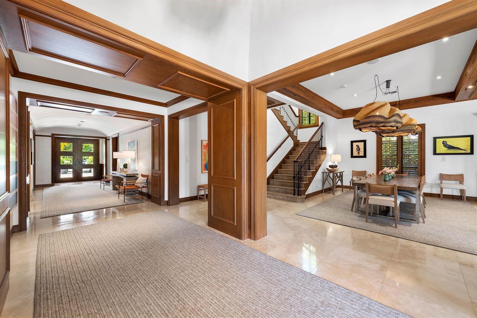 A bright foyer with wood trim leads to a dining room and a staircase — 14 Harbor Drive, FL 33460, FL