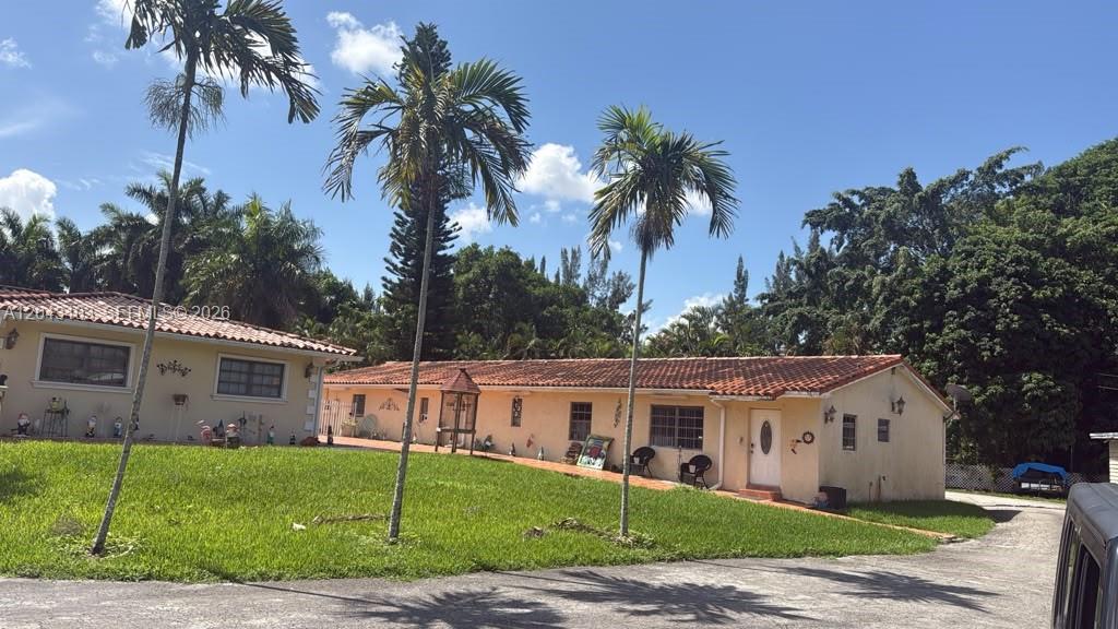 A single-story, light-colored house with a red tile roof sits behind a grassy lawn — 4000 SW 126th Ave, Miramar FL 33027, MIRAMAR, FL